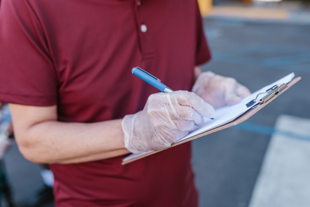 Person filling out a customer feedback checklist on a clipboard